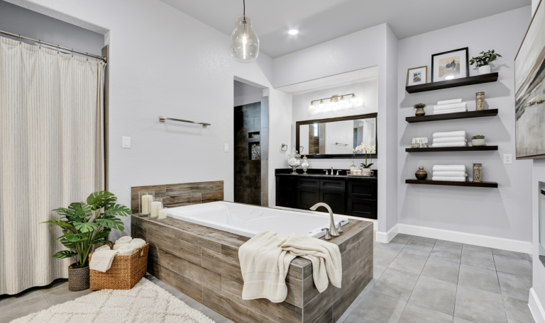Luxury bathroom with soaking tub, modern vanity, and floating shelves.